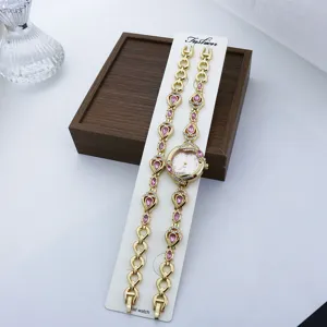 Goldfarbene Quarz-Damenuhr und Armband-Set mit rosa Kristallen und kleinem Zifferblatt.