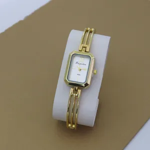 Gold tone quartz bracelet watch for women with stylish rectangular dial and hollow bangle strap.