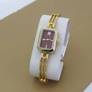 Gold-tone rectangular dial quartz watch for women with stylish bracelet strap, detailed view.