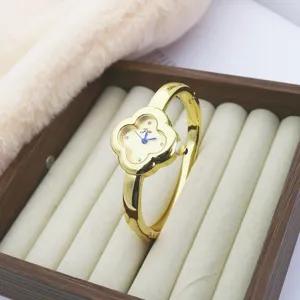 Luxury clover quartz watch for women, stylish diamond bangle watch with golden finish.