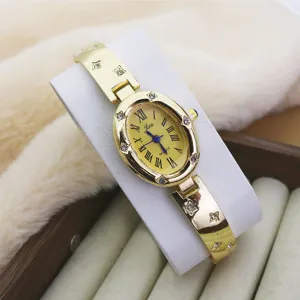 Gold oval quartz women watch with Roman numerals and rhinestone bracelet strap fashion design.