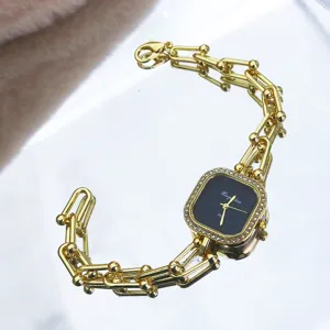 Elegant gold-tone chain strap quartz watch featuring a chic square rhinestone dial design.