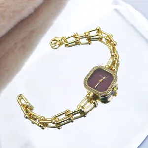 Chic gold-tone chain quartz watch with a square crystal bezel and vintage bracelet design.