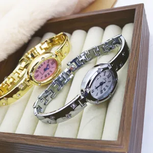 Elegant women quartz watch with oval dial roman numerals and chic bracelet strap.