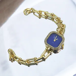 Luxury gold chain quartz watch with square blue dial and rhinestone bezel for women bracelet design.