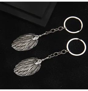 Retro Chinese style yin yang taiji feather pendant keychain detailed close up metal keyring
