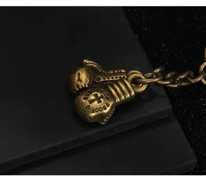 Vintage brass boxing glove metal keychain retro sports pendant fashion gift accessory charm.