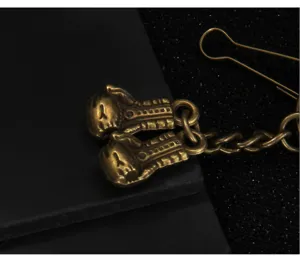 Retro style miniature boxing glove metal keychain, antique brass finish accessory pendant.