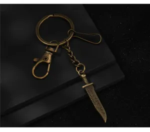Detailed close-up view of an antique bronze metal keychain featuring a mini rune dagger pendant.