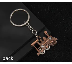 Vintage bronze locomotive keychain with movable wheels and keyring display detail view.