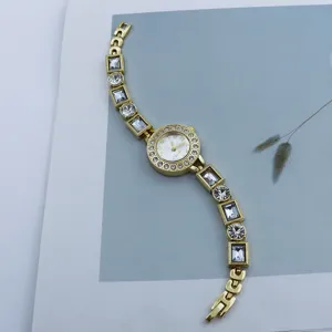 Elegant women gold tone quartz watch featuring sparkling rhinestones and crystal bracelet.