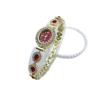 Goldene Damen QuarzUhr mit rotem ovalem Zifferblatt, Strass Lünette und rotem Armband.