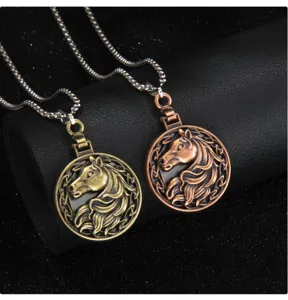 Detailed closeup view of vintage bronze and copper horse head pendant necklaces.