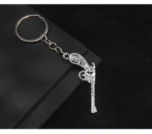 Silver metal pistol shaped keychain, stylish car bag pendant or unique creative gift.