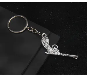 Silver antique pistol keychain metal gun keyring bag pendant car accessory detailed view.