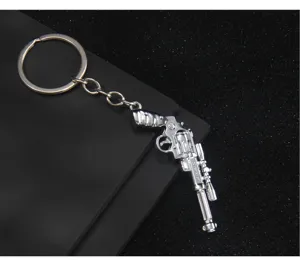 Miniature metal revolver gun keychain, stylish game peripheral accessory for bags and keys.