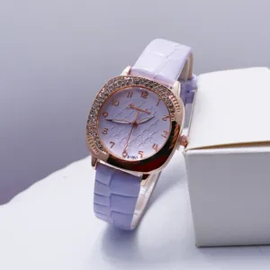 Detail shot of square quartz watch featuring purple leather strap and rhinestone bezel.