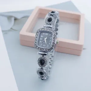 Close-up detail of luxury women rhinestone quartz watch with square dial and teardrop gems.