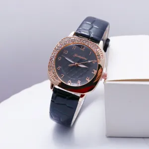 Square quartz women's watch with rhinestone bezel, elegant black leather strap for casual wear.