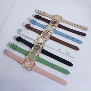 Close-up detail of colorful square quartz women's watches with rhinestone bezels.