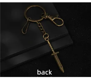 Detailed close-up of the antique bronze metal dagger keychain pendant with sturdy clasp mechanism.
