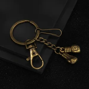 Vintage bronze boxing glove metal keychain main view, stylish sports fashion accessory pendant.