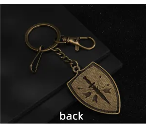 Detailed view of vintage bronze shield sword keychain medieval armor warrior bag pendant.