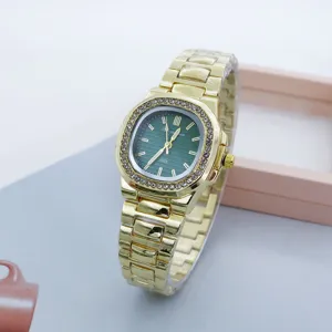Detailed shot of the gold-tone women's square wristwatch featuring a green dial and rhinestone bezel.