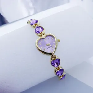 Detail shot of a purple heart quartz watch with crystal bracelet, elegant accessory.