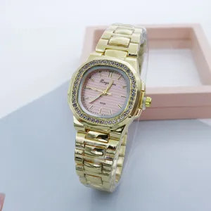 Gold quartz watch for women with pink dial and rhinestone square bezel. Detail view.