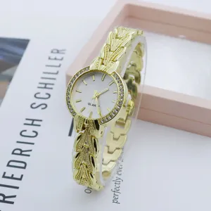 Close-up detail of luxury gold women rhinestone quartz watch with elegant vintage strap texture.