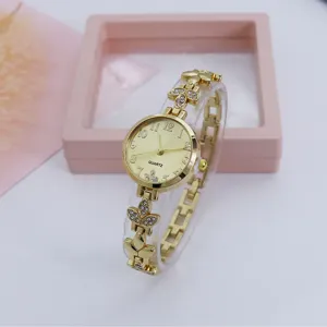 Gold tone clover charm quartz watch detail shot featuring crystal rhinestones and delicate link bracelet.