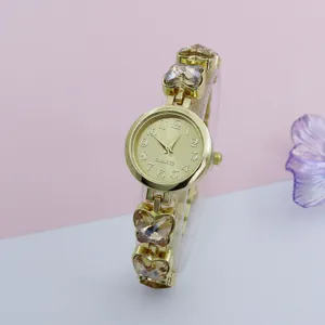 Elegant gold quartz watch featuring sparkling crystal butterfly charms on the delicate bracelet.