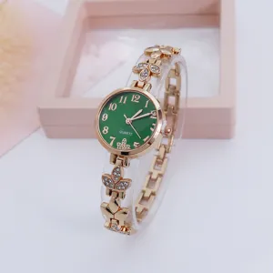 Exquisite clover quartz watch with green dial, sparkling rhinestones, and elegant gold bracelet strap.