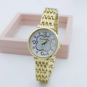 Close-up detail of women gold quartz watch with rhinestone clover dial and metal bracelet.