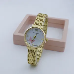 Detail shot of a golden women quartz watch with white dial, pink butterfly and metal bracelet.