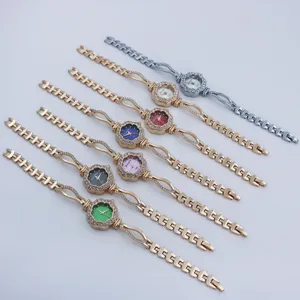 Stylish rhinestone floral dial quartz women watch with elegant metal bracelet.