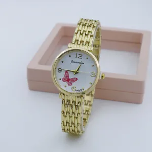 Elegant gold quartz watch detail with white dial, butterfly motif and metal bracelet strap.
