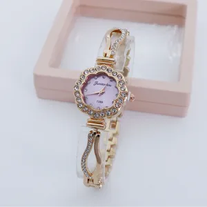 Elegant rhinestone flower quartz watch for women with pink dial and chic metal strap.