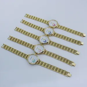 Detail view of women's quartz watches with butterfly dials and gold metal link straps.
