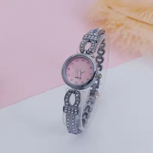 Women's fashion rhinestone bracelet quartz watch with pink dial and sparkling crystal strap.
