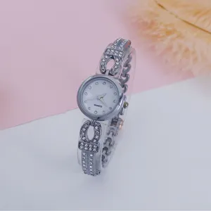 Rhinestone quartz bracelet watch detail, silver metal strap with sparkling crystal stones.