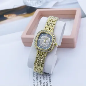 Women square quartz watch with crystal rhinestones, elegant gold metal strap and chic dial design.