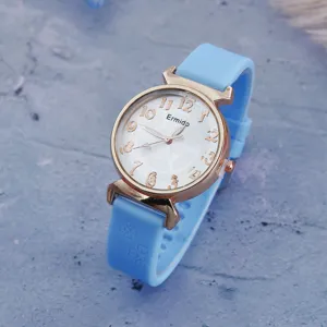 Close-up detail shot of light blue silicone strap quartz watch featuring a white digital dial.