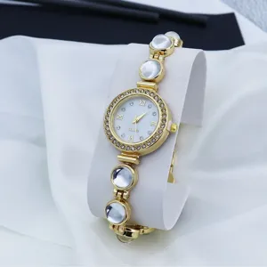 Elegante gouden dames quartz horloge met strass bezel en kralen armband ketting.
