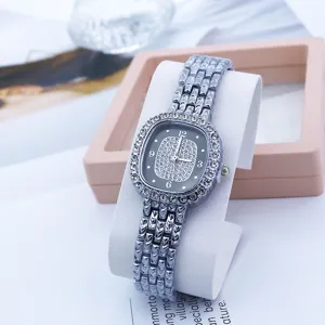 Exquisite square rhinestone quartz watch detail showcasing shimmering dial and elegant metal strap.