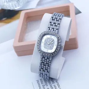 Detailed close-up view of elegant square rhinestone quartz women watch with silver link metal strap.