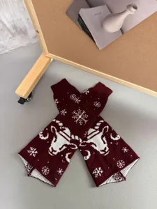 Wine red winter knit leg warmers with white snowflake and ram head pattern for women.