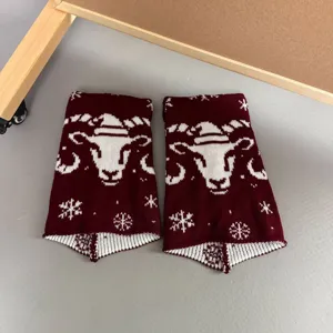Burgundy knit leg warmers with winter snowflake and ram head pattern, cozy slouch socks.