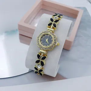Detail view of women fashion quartz watch with rhinestone floral bezel and chic strap.